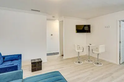 a living room with a blue couch and chairs at Between LA and Orange County Quiet Getaway with Patio in Pico Rivera