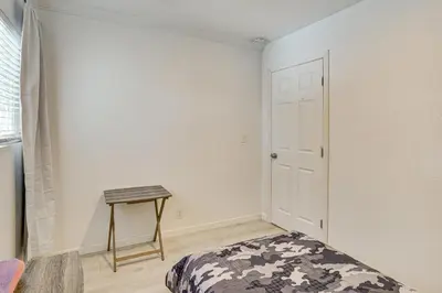 a room with a bed and a table in it at Between LA and Orange County Quiet Getaway with Patio in Pico Rivera