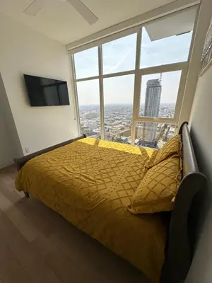 a bedroom with a bed and a large window at 2BR Panoramic City View!! in Los Angeles