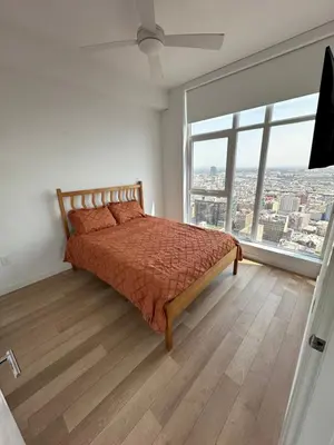 a bedroom with a bed and a large window at 2BR Panoramic City View!! in Los Angeles