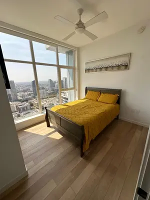 a bedroom with a bed and a large window at 2BR Panoramic City View!! in Los Angeles