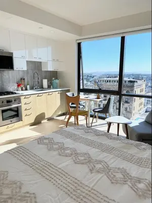 a kitchen and living room with a view of a city at Luxury Vacation Resort Studio Downtown LA in Los Angeles