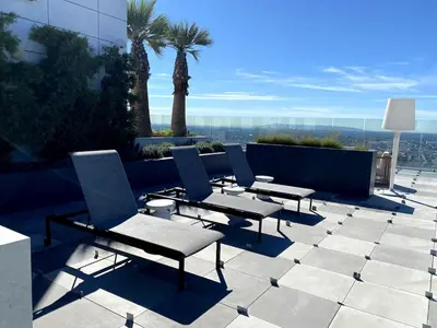 a group of chairs and tables on a patio at Luxury Vacation Resort Studio Downtown LA in Los Angeles