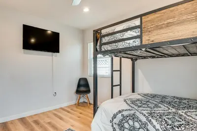 a bedroom with a bunk bed with a flat screen tv at 4 Mi to SoFi Stadium Modern Home with Fenced Yard in Los Angeles