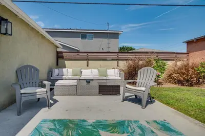 two chairs and a couch on a patio at 4 Mi to SoFi Stadium Modern Home with Fenced Yard in Los Angeles