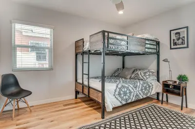 a bedroom with a bunk bed and a desk at 4 Mi to SoFi Stadium Modern Home with Fenced Yard in Los Angeles