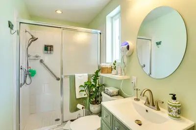 a bathroom with a shower and a sink and a mirror at Cozy Couples Oasis with Pool 3 Mi to Disneyland! in Garden Grove
