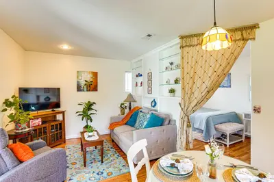 a living room with a couch and a table at Cozy Couples Oasis with Pool 3 Mi to Disneyland! in Garden Grove