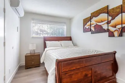 a bedroom with a bed with a wooden dresser at Stylish2BR Patio BBQ Parking Downtown LA in Los Angeles
