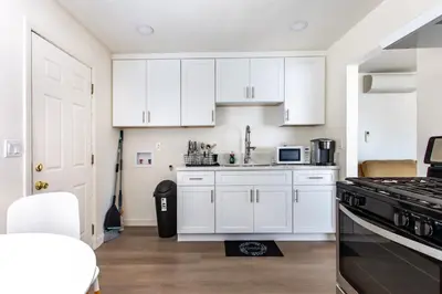 a kitchen with white cabinets and a stove top oven at Stylish2BR Patio BBQ Parking Downtown LA in Los Angeles