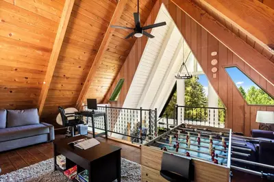 a large living room with a table and a chess board at Casa Huntsted A-Frame Cabin near Snow Valley in Running Springs