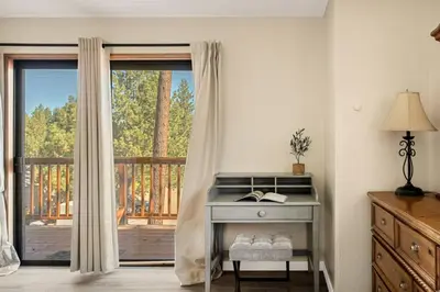 a room with a desk and a window with a porch at The Pinnacle steps to the ski lifts in Big Bear Lake