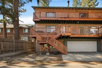 a house with a large deck on the side of it at The Pinnacle steps to the ski lifts in Big Bear Lake