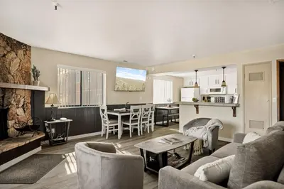 a living room with a couch and a table at The Pinnacle steps to the ski lifts in Big Bear Lake
