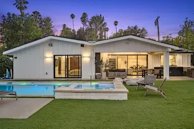 a house with a swimming pool in the yard at Coulson Street Retreat with pool BBQ and more in Los Angeles