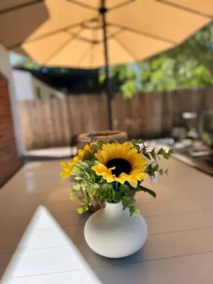 a vase with a sunflower in it on a table at Peaceful, Los Angeles Family Vacation, Relocation Home in Los Angeles