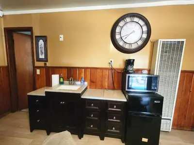 a kitchen with a sink and a clock on the wall at Creek Runner Lodge in Big Bear Lake