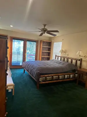 a bedroom with a large bed and a ceiling fan at Home Sweet Home in Frazier Park