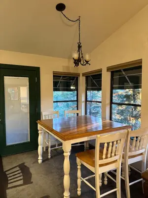 a dining room with a wooden table and chairs at Home Sweet Home in Frazier Park