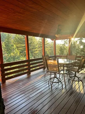 a wooden deck with a table and chairs on it at Home Sweet Home in Frazier Park