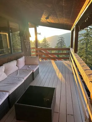 a screened in porch with a couch and a table at Home Sweet Home in Frazier Park