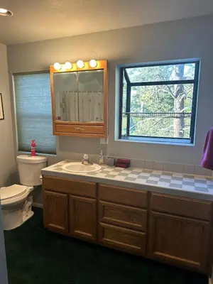a bathroom with a sink and a toilet and a window at Home Sweet Home in Frazier Park