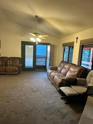 a living room with a couch and a ceiling fan at Charming Pine Mountain Home with Family Space in Frazier Park