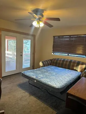 a living room with a bed and a couch at Charming Pine Mountain Home with Family Space in Frazier Park
