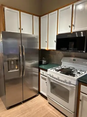 a kitchen with a stainless steel refrigerator and a stove at Charming Pine Mountain Home with Family Space in Frazier Park