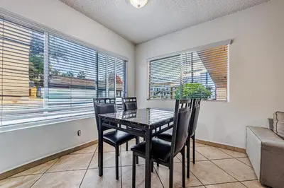 a dining room with a table and chairs and windows at Excellent 1BD Berryman#10 in Los Angeles