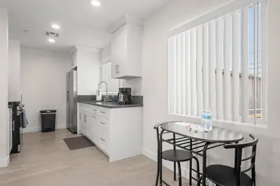 a kitchen with a table and two chairs and a counter at Niagara Haven in Burbank