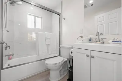 a white bathroom with a toilet and a shower at Niagara Haven in Burbank