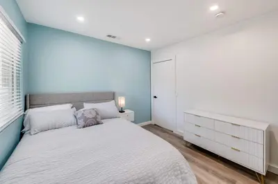 a bedroom with a large bed and a blue wall at 4BR Escape - Mtn Views Private BBQ in Thousand Oaks