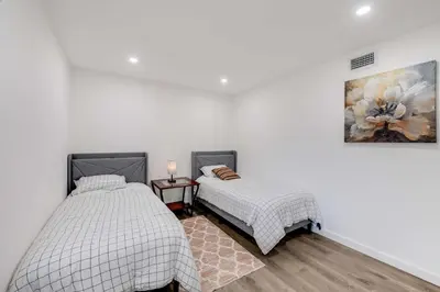 a bedroom with two beds and a painting on the wall at 4BR Escape - Mtn Views Private BBQ in Thousand Oaks