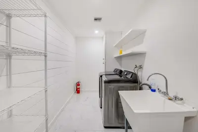 a white kitchen with a washing machine in a room at 4BR Escape - Mtn Views Private BBQ in Thousand Oaks