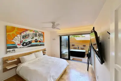 a bedroom with a bed and a painting on the wall at Rad Stay Open Concept House in Mar Vista in Los Angeles