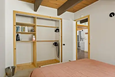 a bedroom with a bed and a book shelf at The Crown A-Frame Gated Central AC Lake Access in Lake Arrowhead