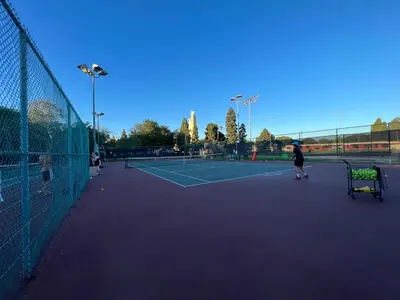 a group of people playing tennis on a tennis court at Cheerful house with EV, Parking & backyard in Los Angeles