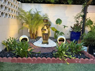a garden with a statue in the middle of a yard at Modern Studio with Private Patio in Los Angeles