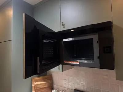 a kitchen with two microwaves hanging from the wall at The Garden Escape in Los Angeles