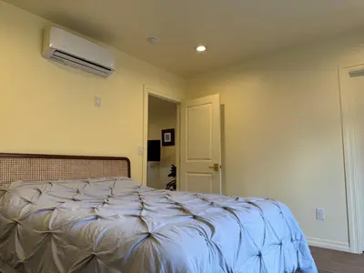 a bedroom with a bed and a air conditioner at The Garden Escape in Los Angeles