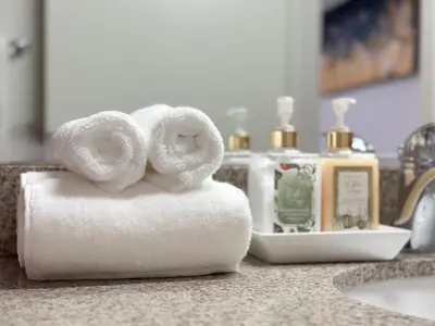 a pile of rolled towels on a bathroom counter at 2BR Coastal Retreat Walk to Beach, free parking in Los Angeles