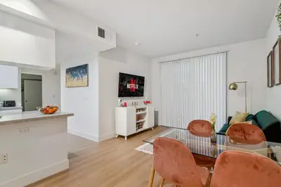 a kitchen and a living room with a table and chairs at 2BR Coastal Retreat Walk to Beach, free parking in Los Angeles