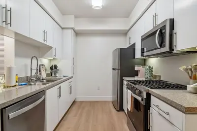 a kitchen with white cabinets and stainless steel appliances at 2BR Coastal Retreat Walk to Beach, free parking in Los Angeles