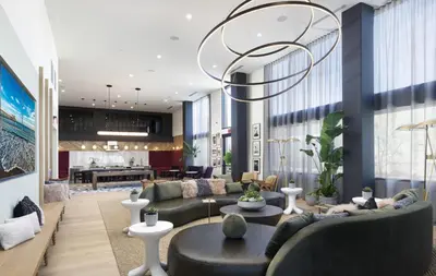 a living room with a couch and a table at Noho Alexan Modern 2bed Duo with FREE Parking in Garnsey
