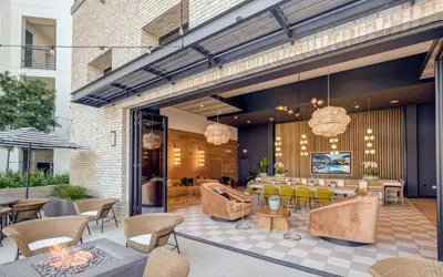 a restaurant with yellow chairs and tables in a building at Noho Alexan Modern 2bed Duo with FREE Parking in Garnsey