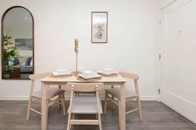 a dining room table with chairs and a mirror at Hollywood Stars 2 Bedroom Apartment in Los Angeles