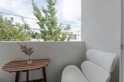 a balcony with a table and chairs and a window at Hollywood Stars 2 Bedroom Apartment in Los Angeles