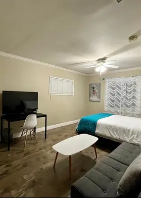 a bedroom with a bed and a desk and a television at Entire 4BR 4BA House in West Covina Modern Private Comfortable in West Covina