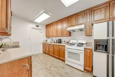 a kitchen with wooden cabinets and white appliances at Entire 4BR 4BA House in West Covina Modern Private Comfortable in West Covina
